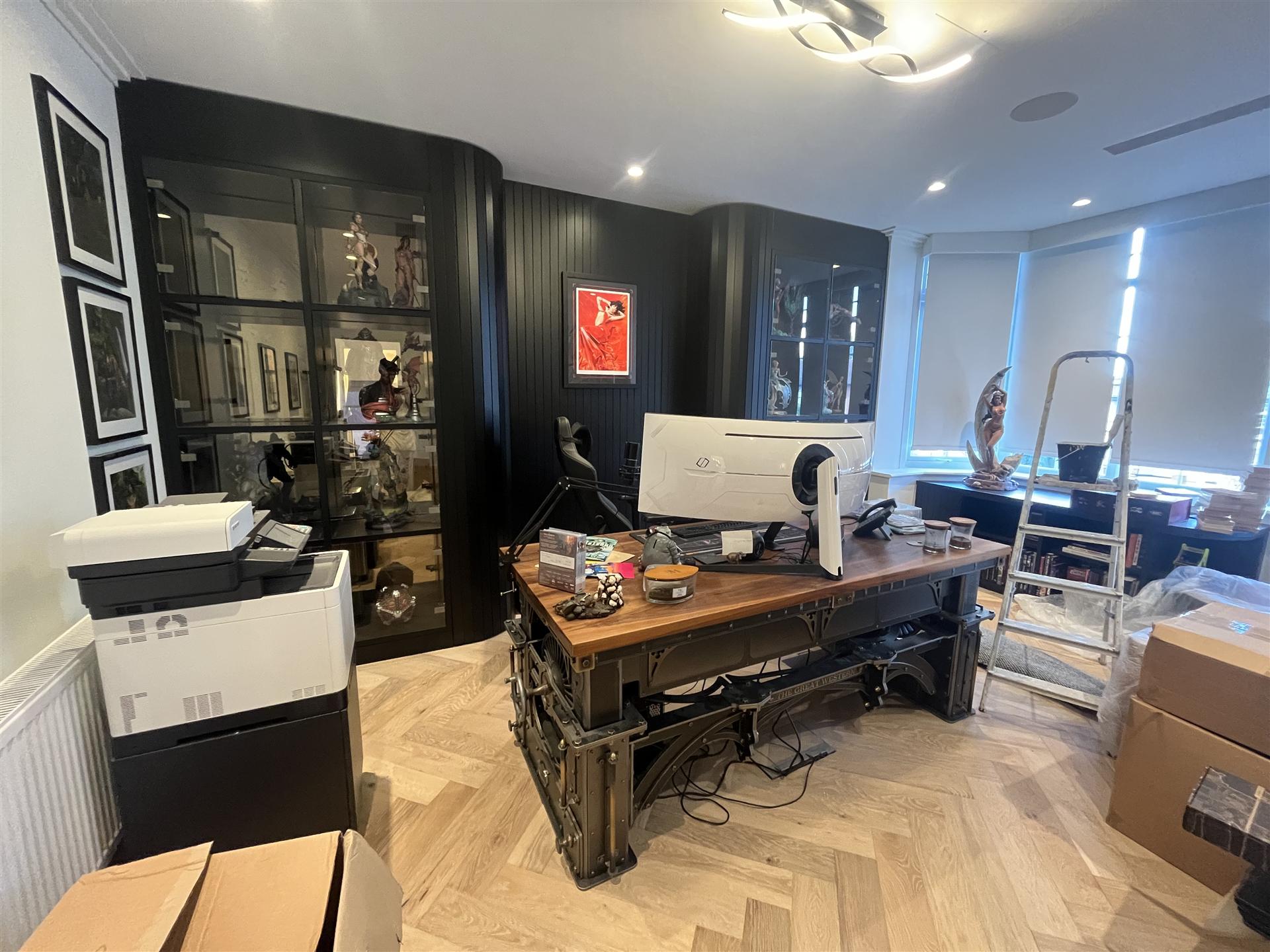 Luxury home office with curved black display wall, Essex